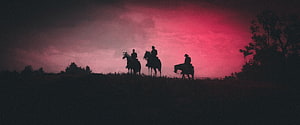 Red Dead Redemption 2 Silhouette of Three Riders on a Hill Against a Crimson Sky HD wallpaper