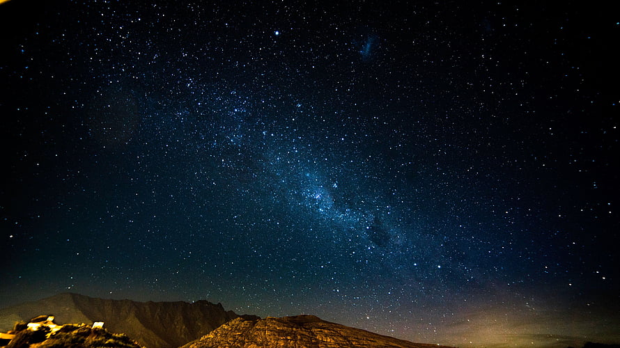 Milky Way Galaxy Arching Over Dark Mountain Ranges Under a Star-Filled Night Sky HD wallpaper