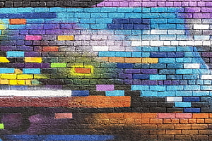 Vibrant multicolored brick wall with abstract street art and graffiti patterns HD wallpaper