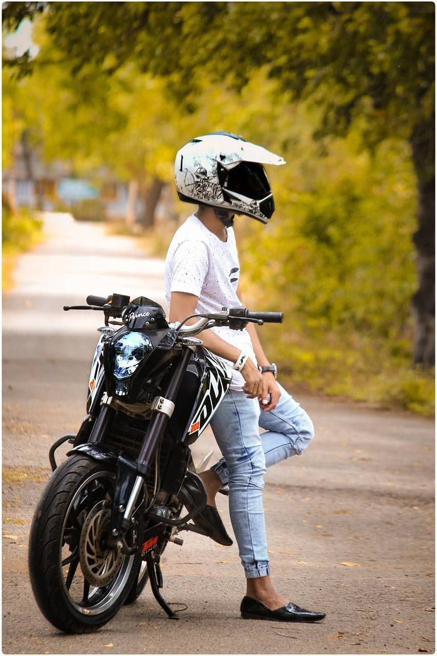 Young Rider in White Helmet Posing with Black Sport Motorcycle on Tree-Lined Road HD phone wallpaper