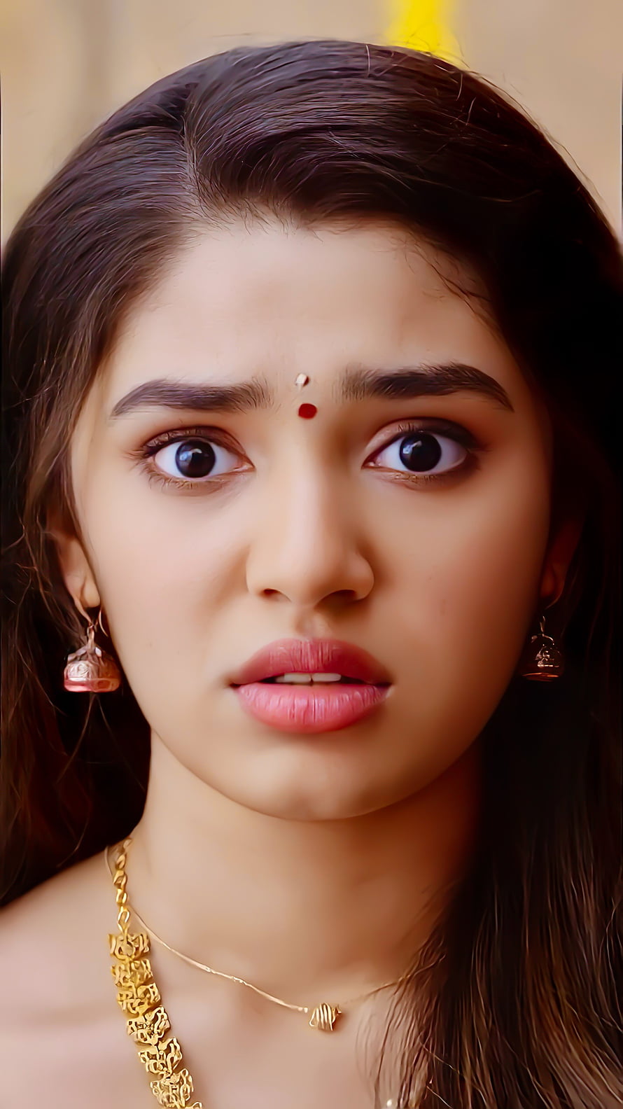 Portrait of a young Indian woman with a bindi, wearing traditional gold jewelry and looking directly at the camera with a surprised expression, Krithi shetty, nose, organ HD phone wallpaper