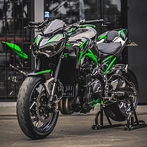 Kawasaki Z900 motorcycle in black and green color scheme parked on a stand HD phone wallpaper