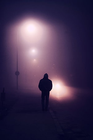 Lone Silhouette Walking Through Thick Purple Fog Under Streetlights at Night HD phone wallpaper