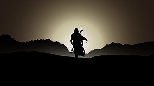 The Mandalorian Silhouette Standing on a Ridge Against a Glowing Sky HD wallpaper
