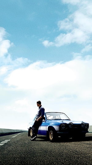 Paul Walker Leaning Against Blue Classic Car on Open Road Under Blue Sky HD phone wallpaper