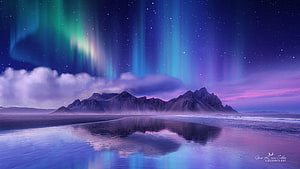 Vibrant Aurora Borealis Over Mountainous Coastline with Reflective Water Surface HD wallpaper