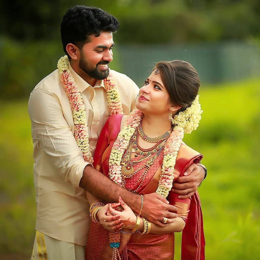 Indian Bride and Groom in Traditional Wedding Attire with Flower Garlands HD wallpaper