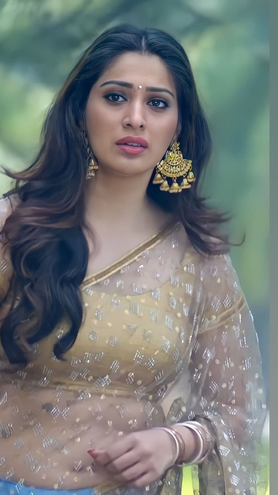 Sai Pallavi in a shimmering gold saree with traditional jewelry and wavy hair HD phone wallpaper