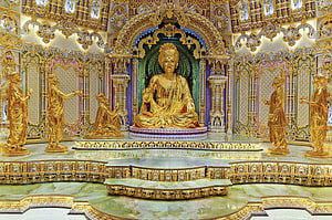 Golden Swaminarayan Statue in Ornate Akshardham Temple Sanctuary HD wallpaper