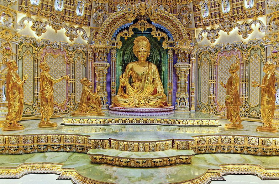 Golden Swaminarayan Statue in Ornate Akshardham Temple Sanctuary HD wallpaper