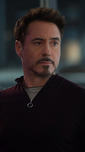 Robert Downey Jr as Tony Stark in a dark zip-up sweater with a serious expression HD phone wallpaper