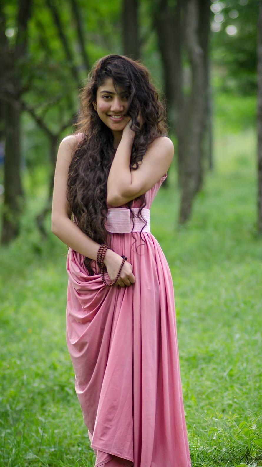 Beautiful Woman in Pink Dress Standing in Green Forest with Long Curly Hair, South Heroine, Sai Pallavi HD phone wallpaper