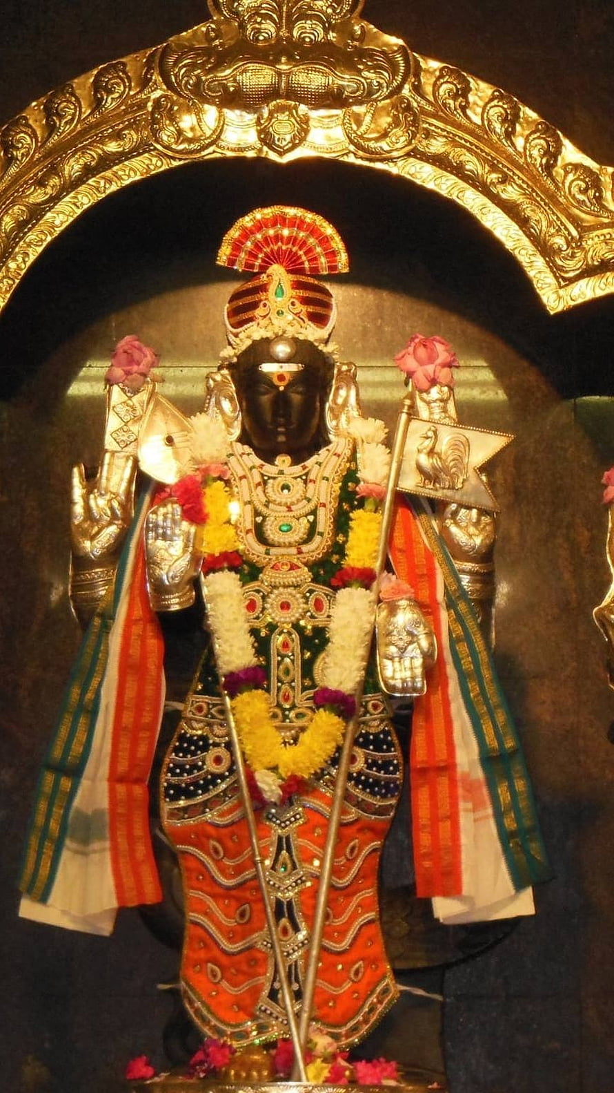 Ornate Black Stone Statue of Hindu Deity Murugan with Golden Crown and Floral Garlands HD phone wallpaper