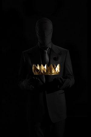 Faceless figure in a black suit holding a faceted gold crown against a dark background HD phone wallpaper