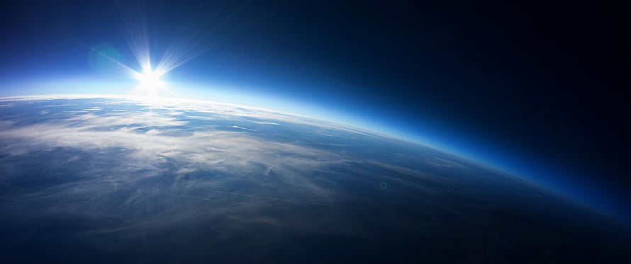 Earth Sunrise From Orbit With Bright Sun Flare And Atmospheric Glow HD wallpaper