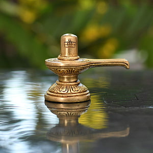 Traditional Brass Diya Oil Lamp With Intricate Carvings Reflected In Water HD phone wallpaper