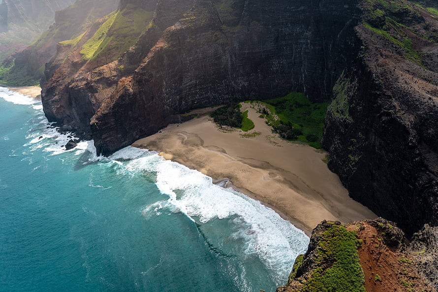 Aerial View of Secluded Coastal Beach with Turquoise Waters and Dramatic Cliffs HD wallpaper