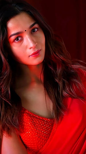 Alia Bhatt in a red sequined saree with dramatic warm lighting and long wavy hair HD phone wallpaper