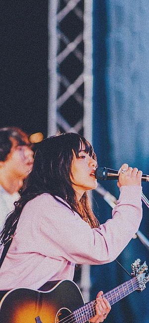 Aimyon performing live on stage with acoustic guitar and microphone HD phone wallpaper