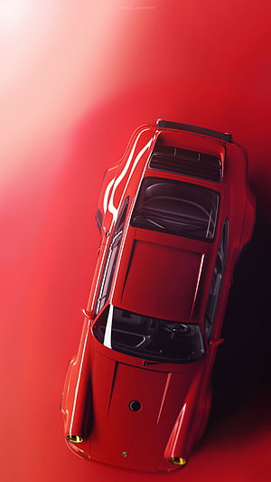 Top-down view of a glossy red classic sports car with a black spoiler on a red background HD phone wallpaper