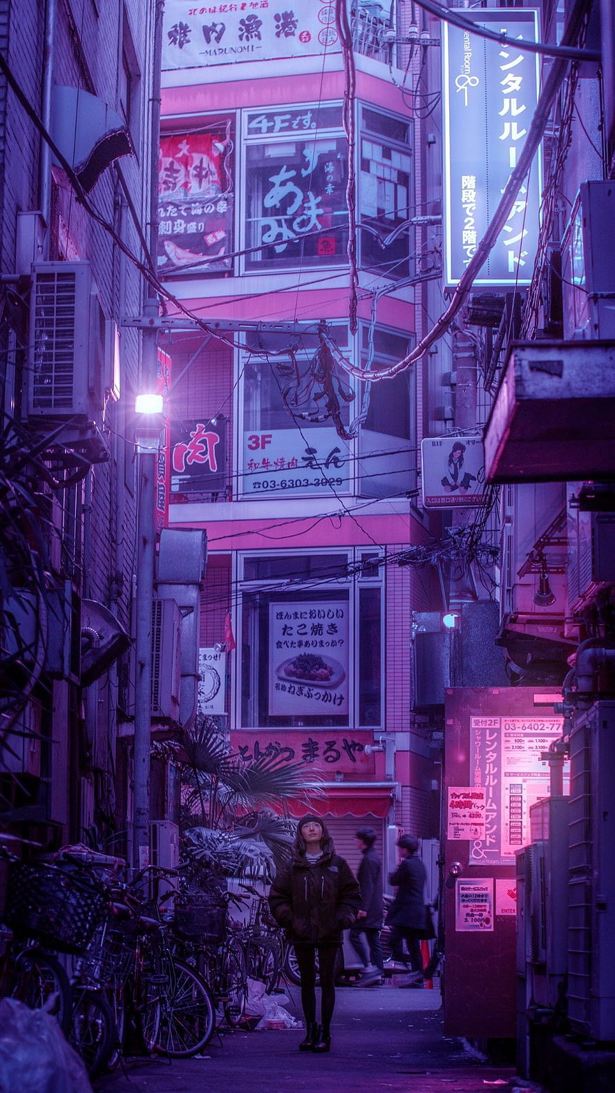 Neon-lit Tokyo alleyway at night with a lone figure and dense urban signage HD phone wallpaper