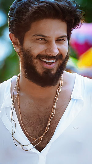 Dulquer Salmaan smiling portrait in white shirt with gold necklace HD phone wallpaper