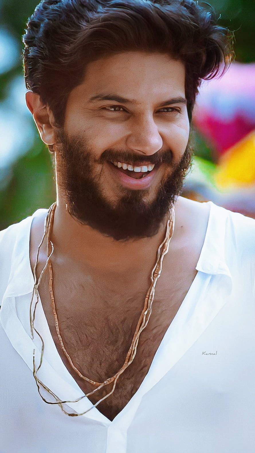 Dulquer Salmaan smiling portrait in white shirt with gold necklace HD phone wallpaper