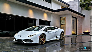White Lamborghini Huracan with Gold Wheels Parked in Front of Modern Luxury Residence HD wallpaper