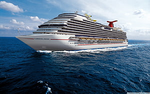 Carnival Magic cruise ship sailing across the open ocean under a bright blue sky HD wallpaper
