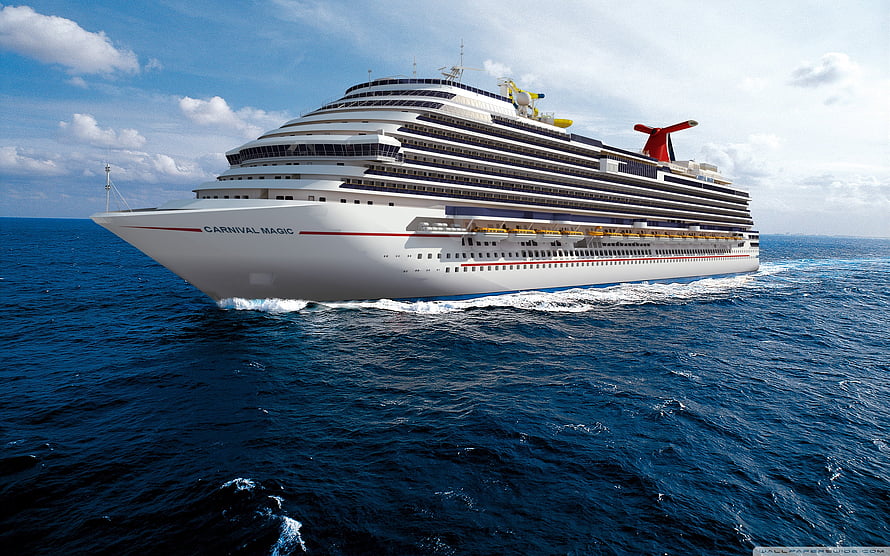 Carnival Magic cruise ship sailing across the open ocean under a bright blue sky HD wallpaper