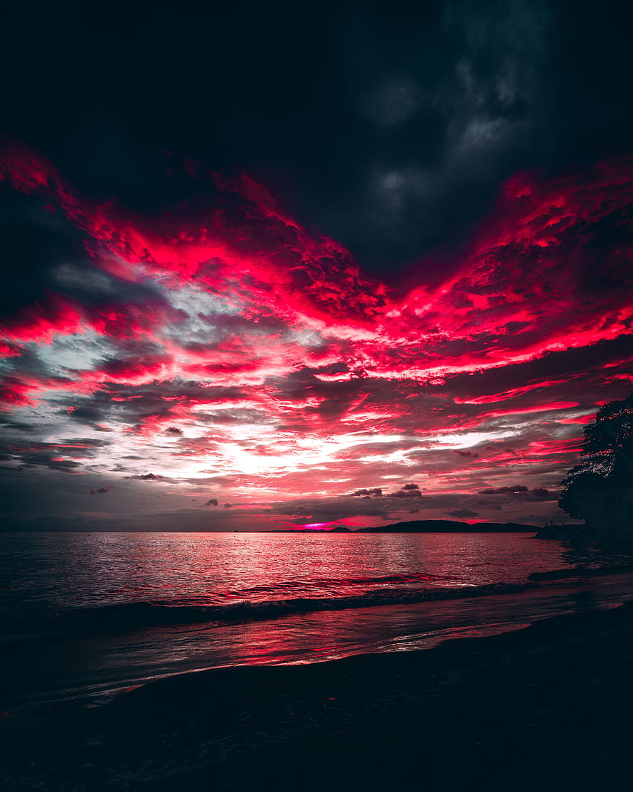 Dramatic Crimson Sunset Over Ocean With Fiery Red Clouds And Dark Silhouettes HD phone wallpaper