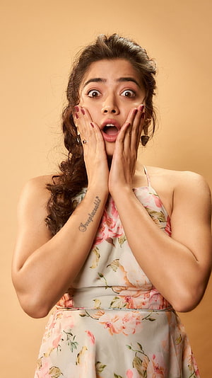 Woman in Floral Dress Expressing Shock and Surprise with Hands on Face, Rashmika mandanna, telugu actress HD phone wallpaper