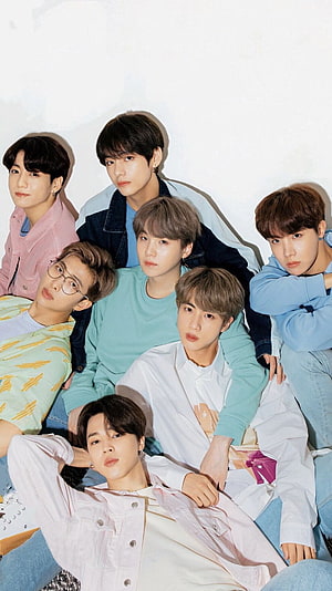 BTS members in pastel casual outfits posing together for a group photo HD phone wallpaper