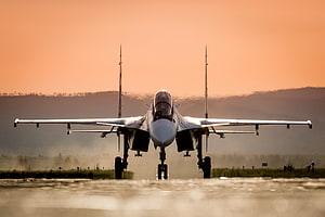 Sukhoi Su-30 Fighter Jet Landing on Runway at Golden Hour HD wallpaper