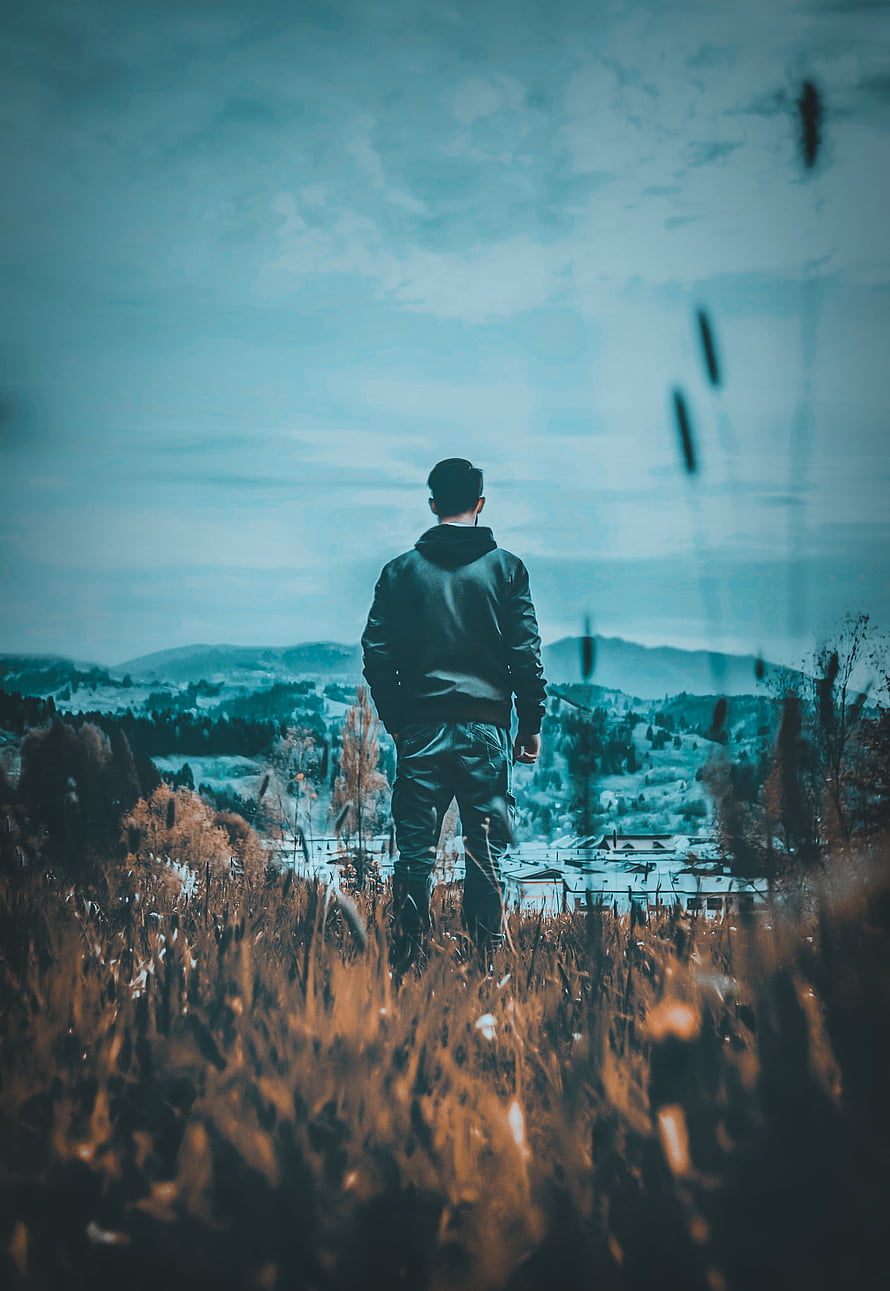 Man Standing in Tall Grass Overlooking Mountain Valley Landscape, Sad boy mood off, cloud, sky HD phone wallpaper