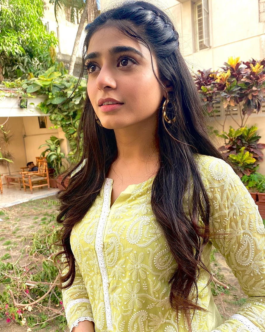 Sehar Khan in a yellow embroidered kurta with long wavy hair in a garden setting HD phone wallpaper