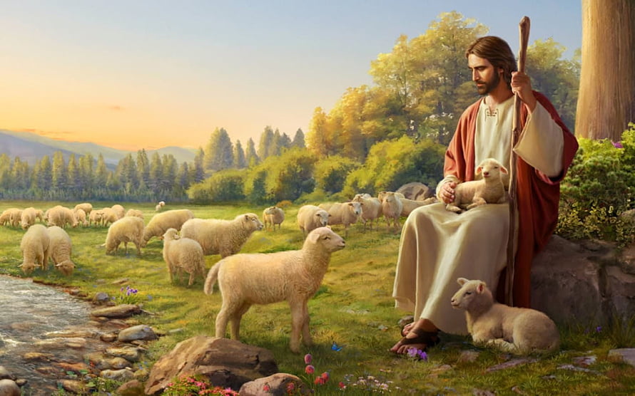 Jesus Christ as the Good Shepherd Sitting with Lambs in a Peaceful Pastoral Landscape HD wallpaper