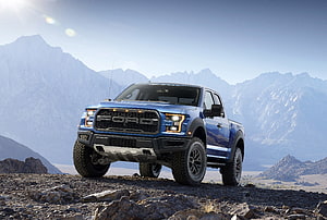 Blue Ford F-150 Raptor Pickup Truck Parked on Rocky Mountain Terrain HD wallpaper