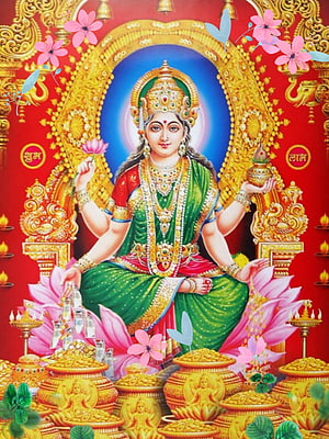Goddess Lakshmi Seated on Lotus with Gold Coins and Flowers HD phone wallpaper