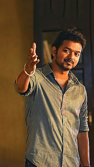 Vijay Thalapathy in a Dramatic Pose Wearing a Grey Button-Down Shirt HD phone wallpaper