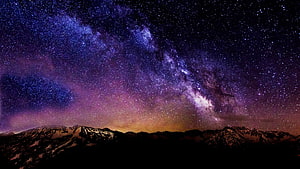 Milky Way Galaxy Arching Over Snow-Capped Mountain Ranges at Night HD wallpaper
