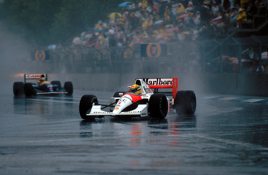 Ayrton Senna in the McLaren MP4-4 during a rainy Formula 1 race HD wallpaper