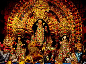 Ornate Durga Puja Murti with Lion and Attendant Deities in Traditional Temple Setting HD wallpaper