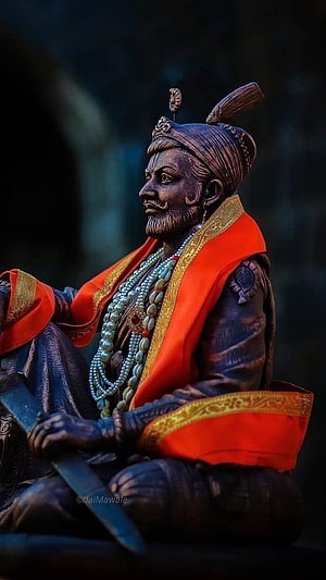 Statue of Chhatrapati Shivaji Maharaj with Sword and Orange Shawl HD phone wallpaper