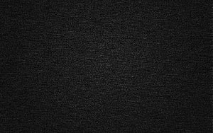 Dark Textured Surface with Subtle Grain and Faint Linear Streaks HD wallpaper