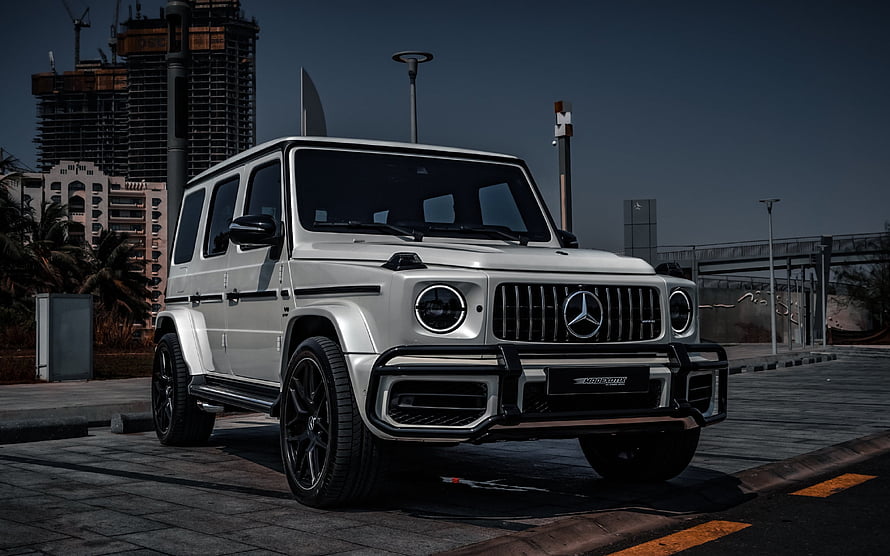 Silver Mercedes-AMG G63 SUV with Black Bull Bar and Urban City Background HD wallpaper