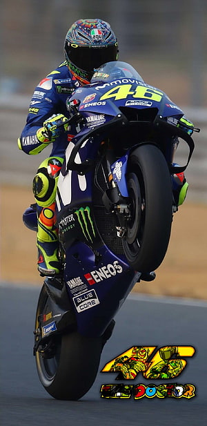 Valentino Rossi performing a wheelie on Yamaha MotoGP bike with Monster Energy and Eneos sponsorship HD phone wallpaper