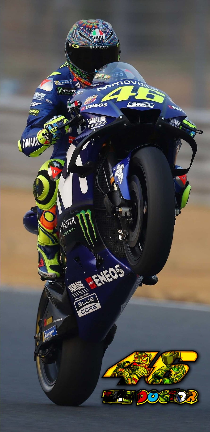 Valentino Rossi performing a wheelie on Yamaha MotoGP bike with Monster Energy and Eneos sponsorship HD phone wallpaper