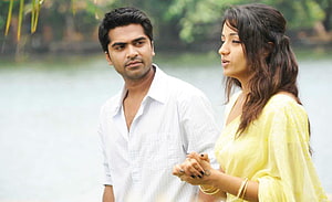 Simbu and Trisha in a romantic lakeside scene from the Tamil film Vinnaithandi Varuvaya HD wallpaper