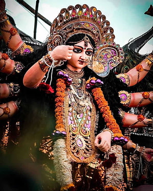 Maa Durga ornate idol with marigold garlands and traditional jewelry HD phone wallpaper